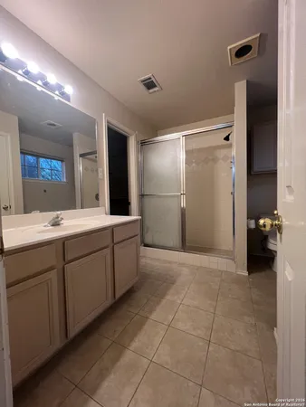 a spacious bathroom with a double vanity sink and a mirror