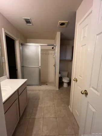 a bathroom with a sink a toilet and a shower