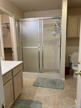 a bathroom with a shower and a sink