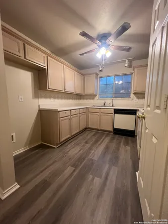 a kitchen with granite countertop a sink and cabinets