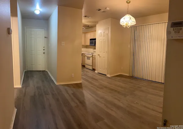 an empty room with wooden floor