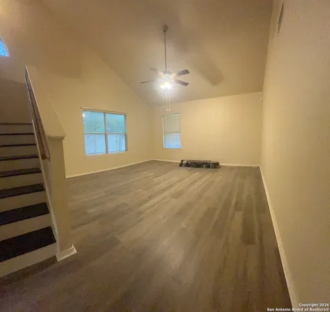 a view of an empty room with wooden floor