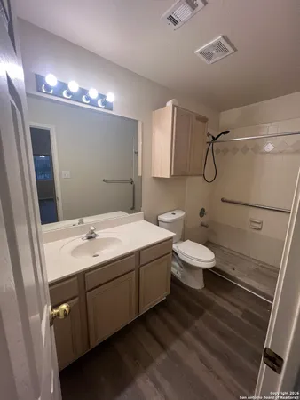 a bathroom with a sink toilet and shower
