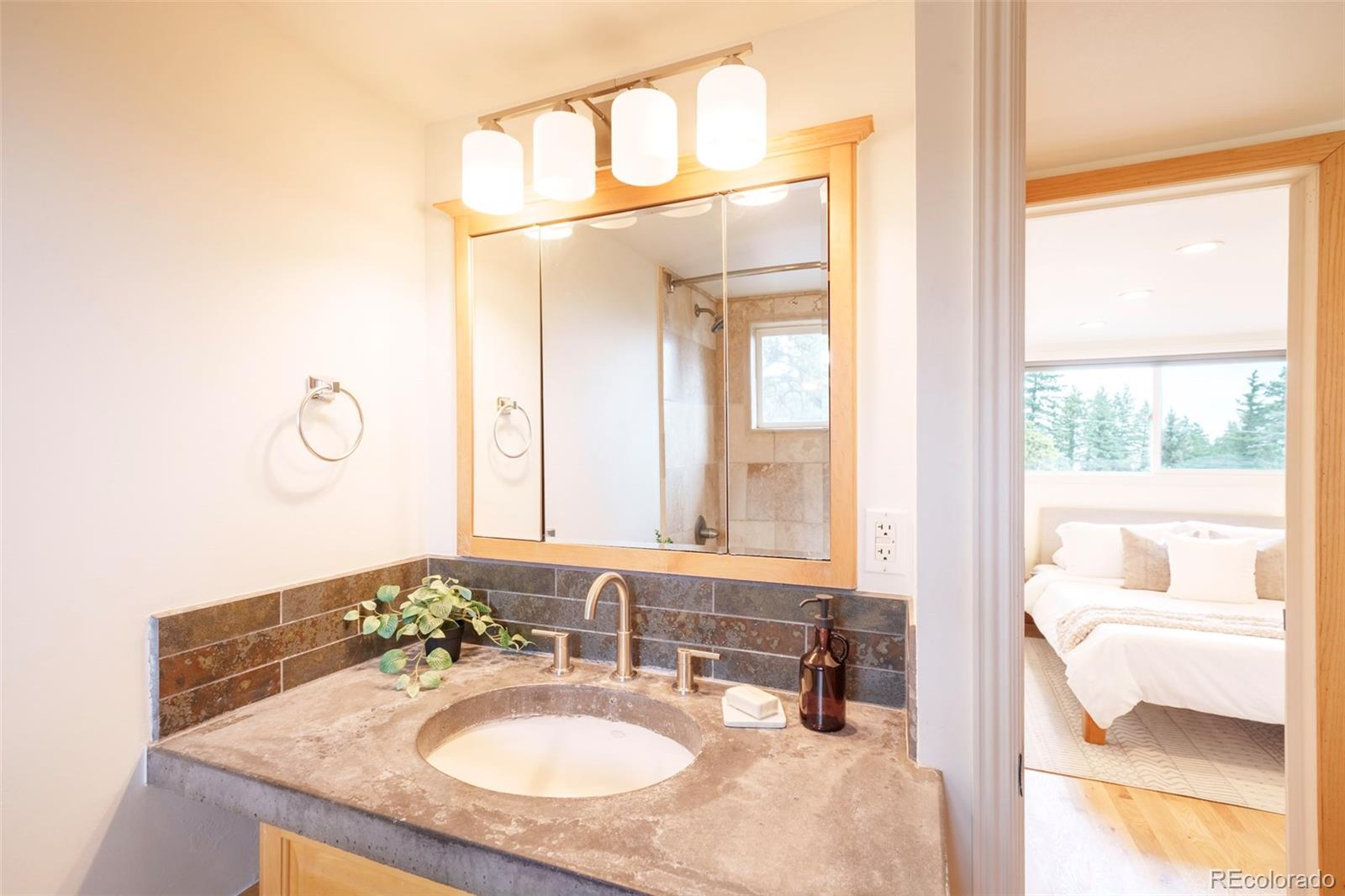 926 Brook Road Boulder, CO 80302 - Photo 24 of 50 a bathroom with a granite countertop sink and a mirror