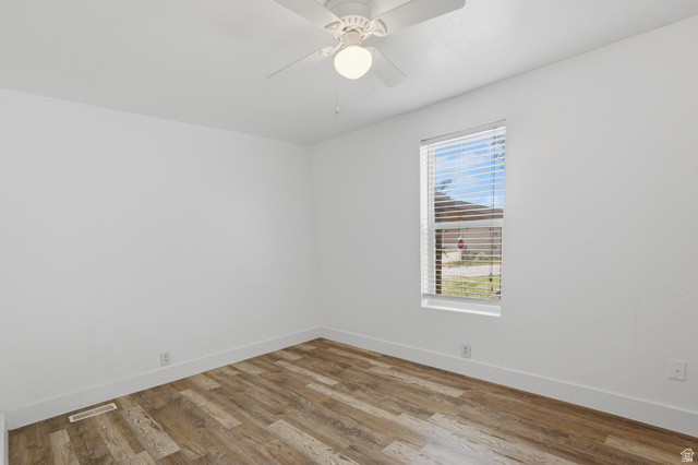 2875 North Hill Field Road, Unit 111 Layton, UT 84041 - Photo 20 of 30 Empty room featuring light wood finished floors and ceiling fan