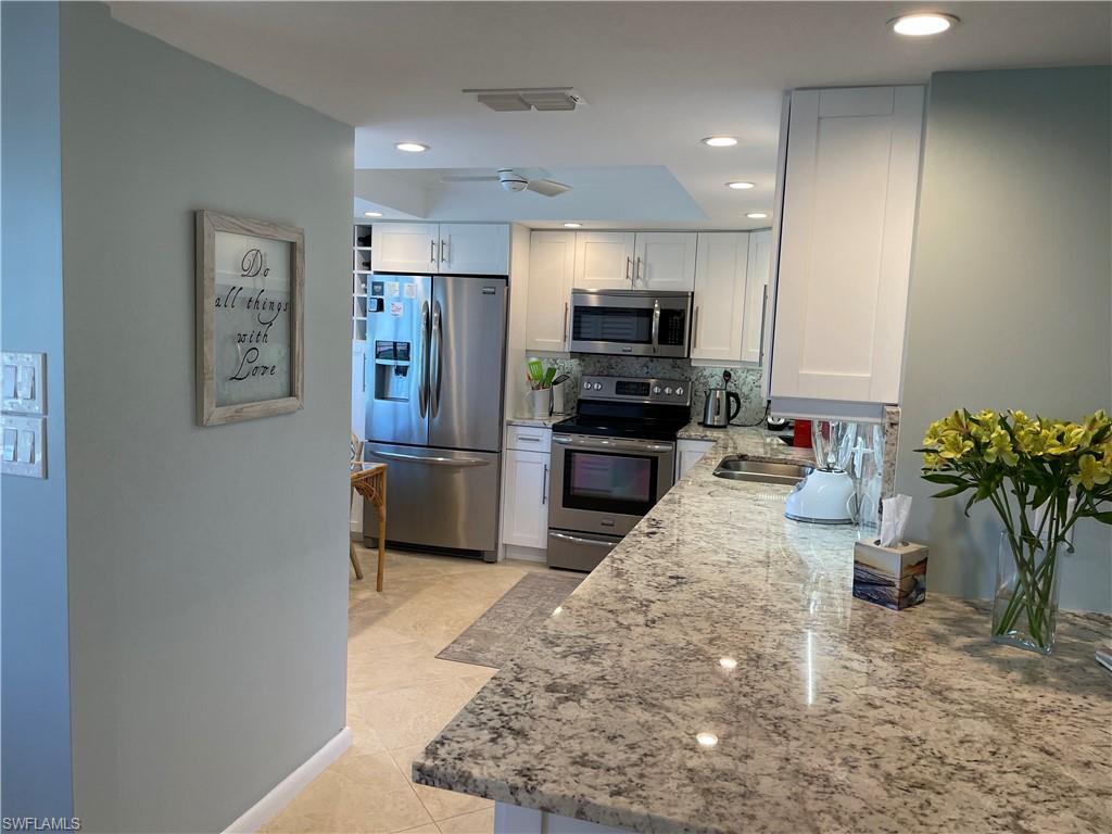 261 Quails Nest Road, Unit 6 Naples, FL 34112 - Photo 11 of 32 a kitchen with sink refrigerator and microwave