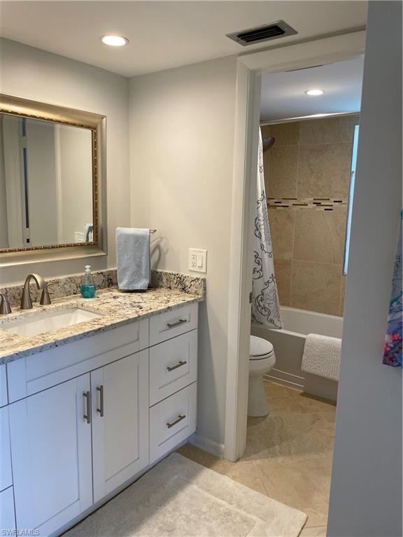 261 Quails Nest Road, Unit 6 Naples, FL 34112 - Photo 21 of 32 a bathroom with a granite countertop sink toilet and shower