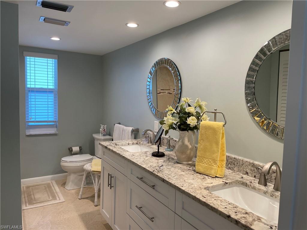 261 Quails Nest Road, Unit 6 Naples, FL 34112 - Photo 26 of 32 a bathroom with a granite countertop sink and a mirror