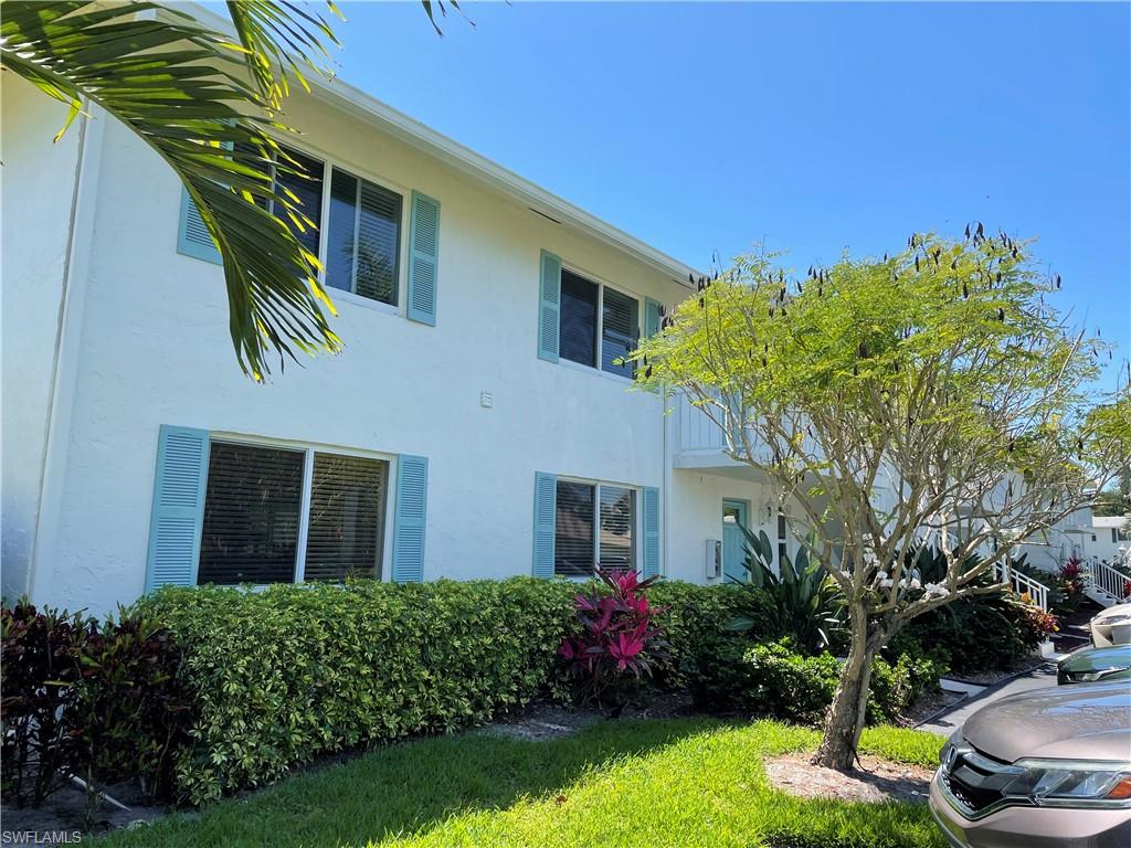 261 Quails Nest Road, Unit 6 Naples, FL 34112 - Photo 3 of 32 a front view of a house with a yard