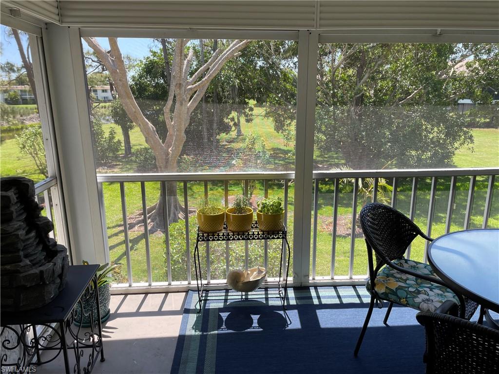 261 Quails Nest Road, Unit 6 Naples, FL 34112 - Photo 5 of 32 a view of a room with balcony and furniture