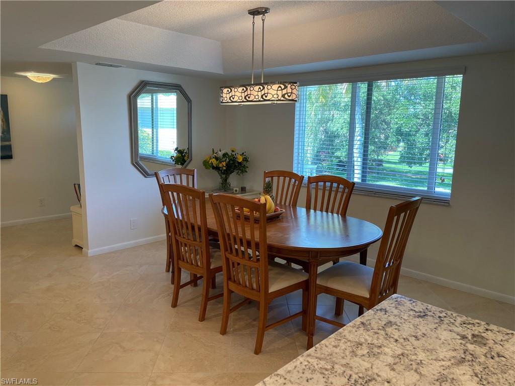 261 Quails Nest Road, Unit 6 Naples, FL 34112 - Photo 8 of 32 a view of a dining room with furniture window and outside view