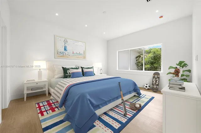 a bedroom with a bed and a window