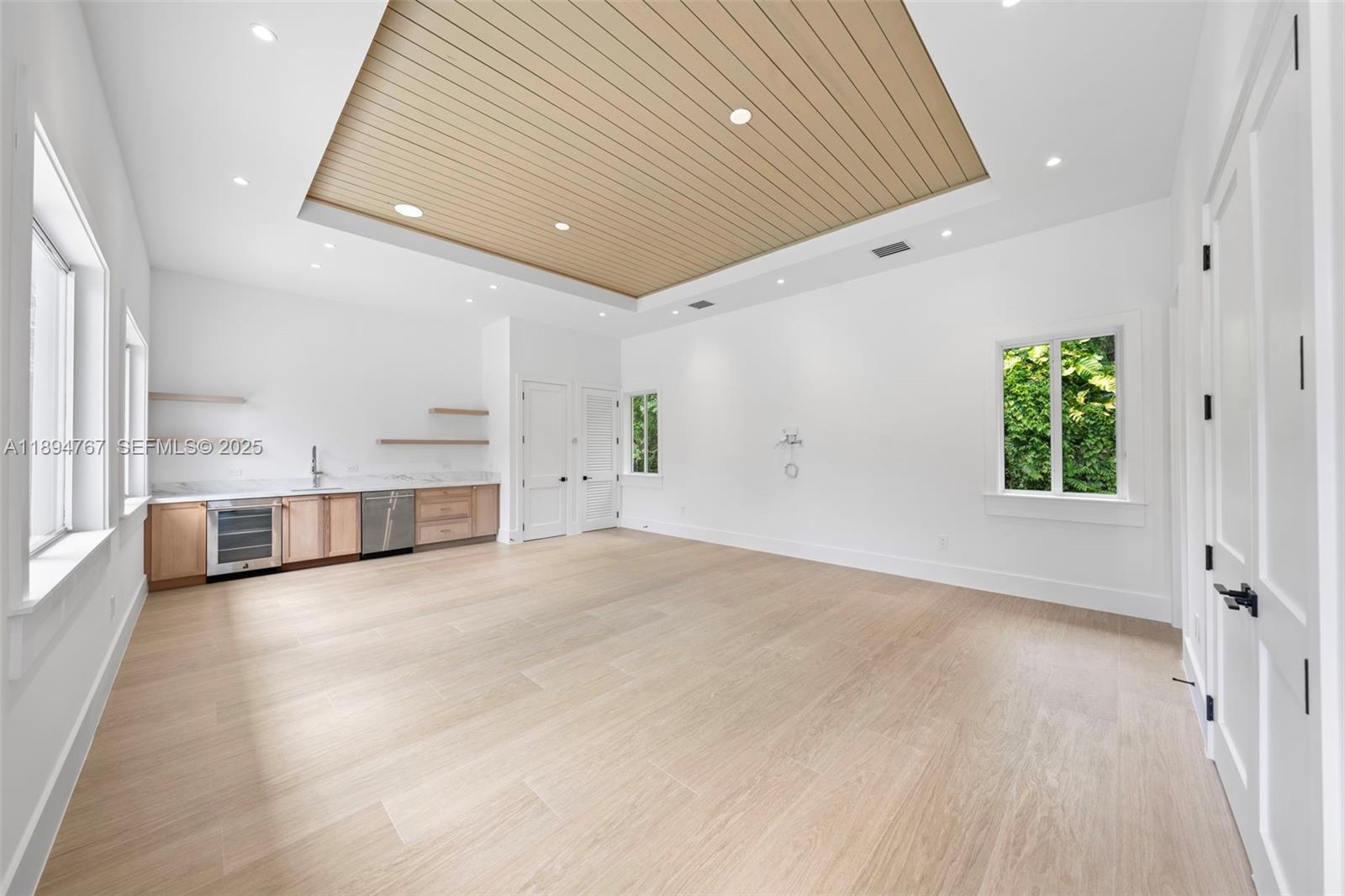 7900 Southwest 118th Street Pinecrest, FL 33156 - Photo 25 of 41 a view of an empty room with a window and wooden floor