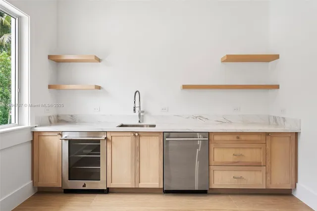 a utility room with sink dryer and washer