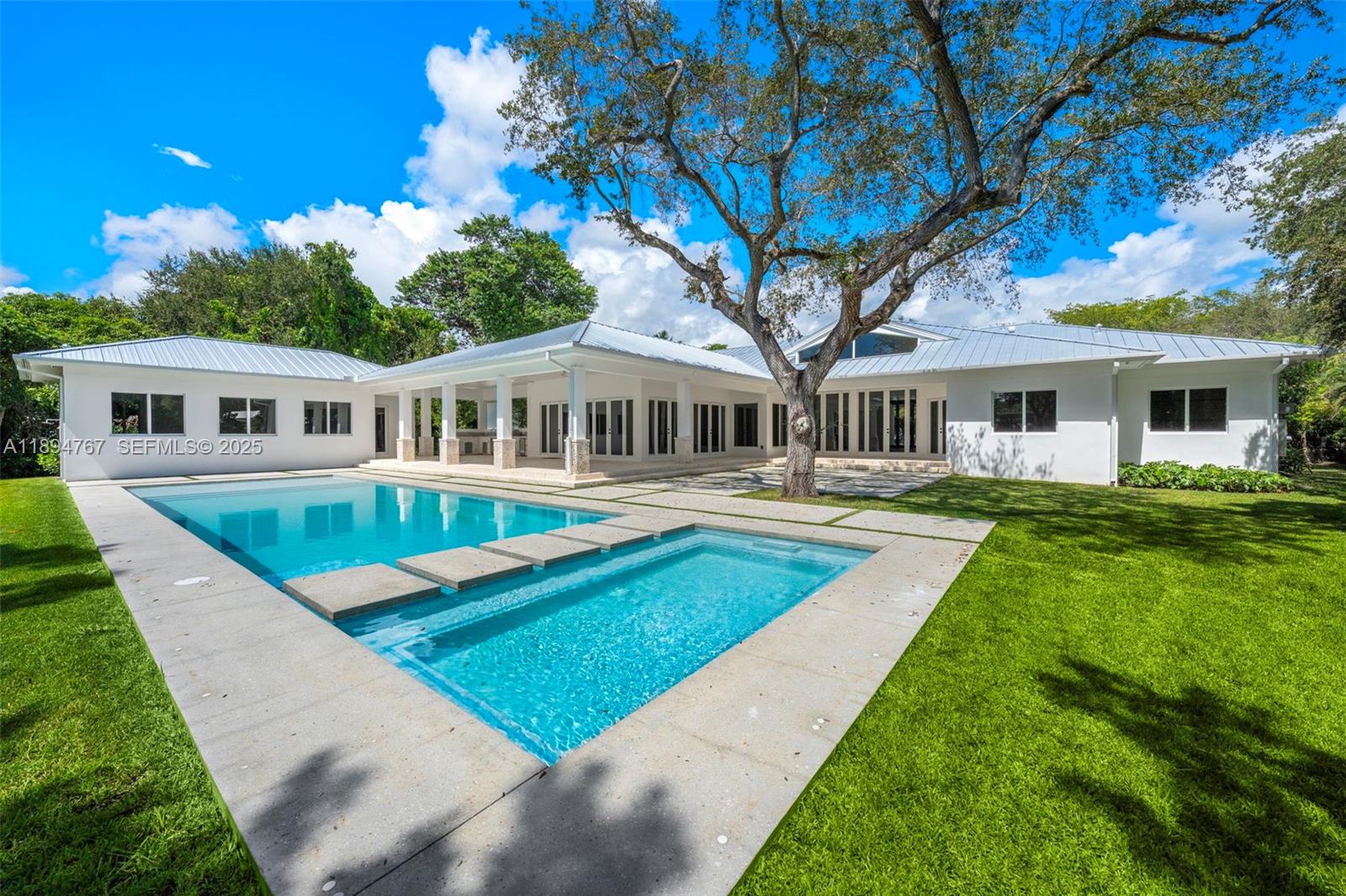7900 Southwest 118th Street Pinecrest, FL 33156 - Photo 32 of 41 a view of a house with a yard deck and a patio