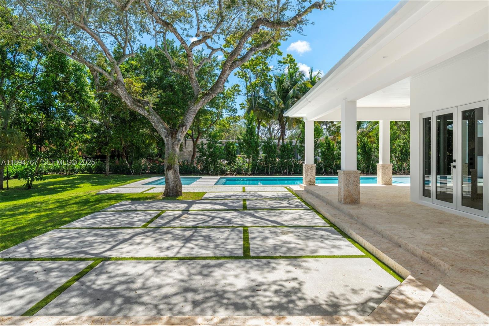 7900 Southwest 118th Street Pinecrest, FL 33156 - Photo 35 of 41 a view of a house with backyard and swimming pool