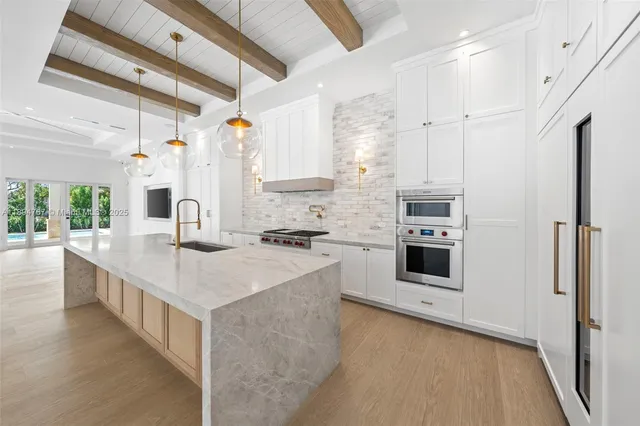 a kitchen with a sink stove and refrigerator