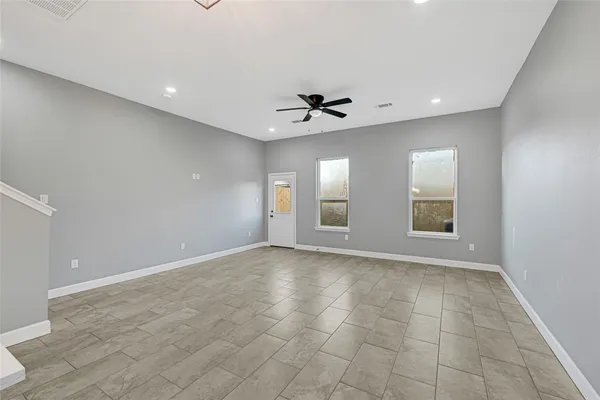 an empty room and a gallery with wooden floor