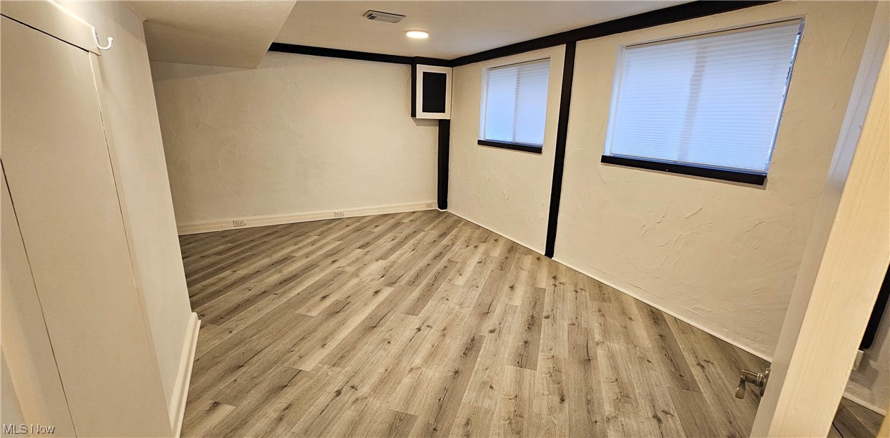 19755 Upper Terrace Road Euclid, OH 44117 - Photo 28 of 38 Lower level Rec room with luxury vinyl tile flooring