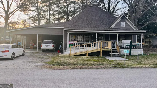 a view of a house with a yard patio and a garden