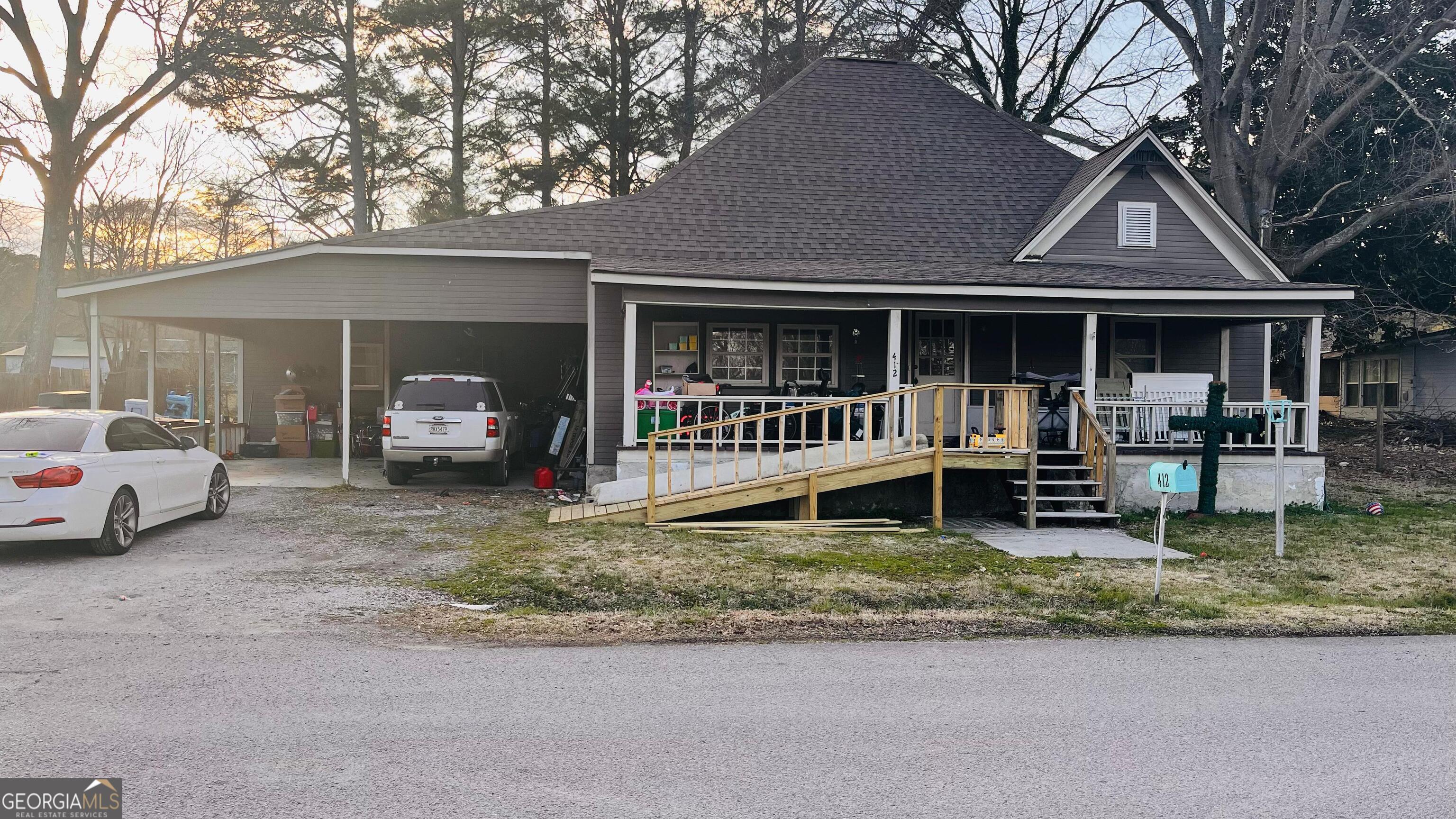a view of a house with a yard patio and a garden