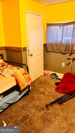a bedroom with a bed and a couch