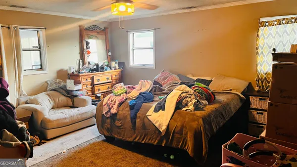 a bed sitting in a bedroom next to a window