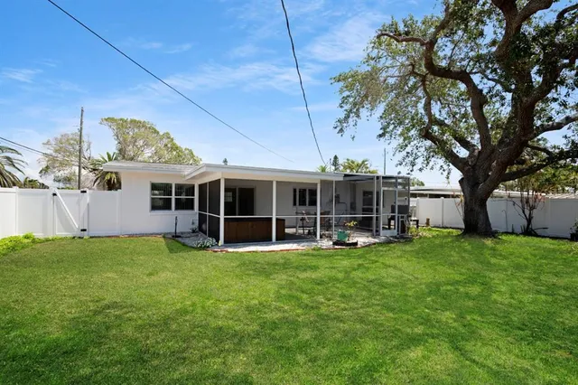 a view of a house with backyard porch and sitting area