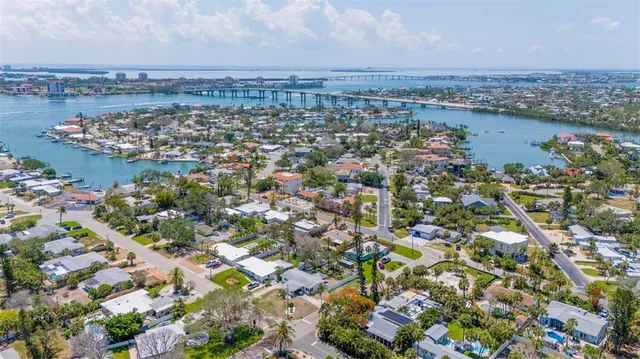 an aerial view of a houses with a lake