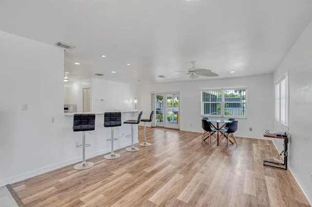 a view of a living room and chandelier with wooden floor