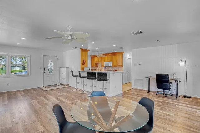 a living room with furniture a flat screen tv and a table