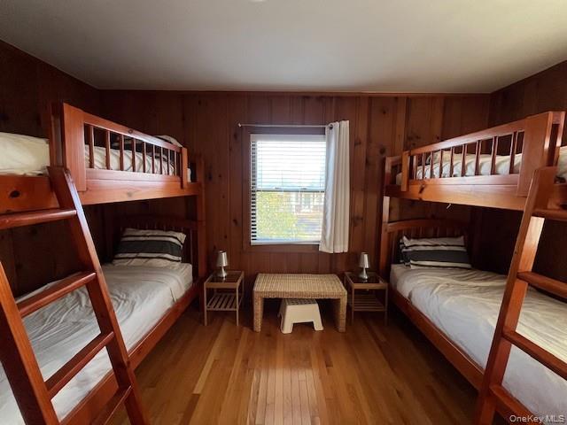 35 Sloop Walk Ocean Beach, NY 11770 - Photo 11 of 21 Bedroom featuring wood walls and wood-type flooring