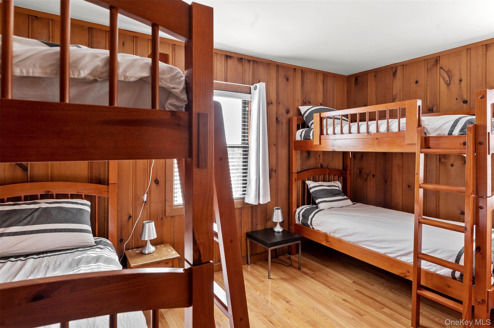 35 Sloop Walk Ocean Beach, NY 11770 - Photo 14 of 21 Bedroom featuring light wood-style flooring and wood walls