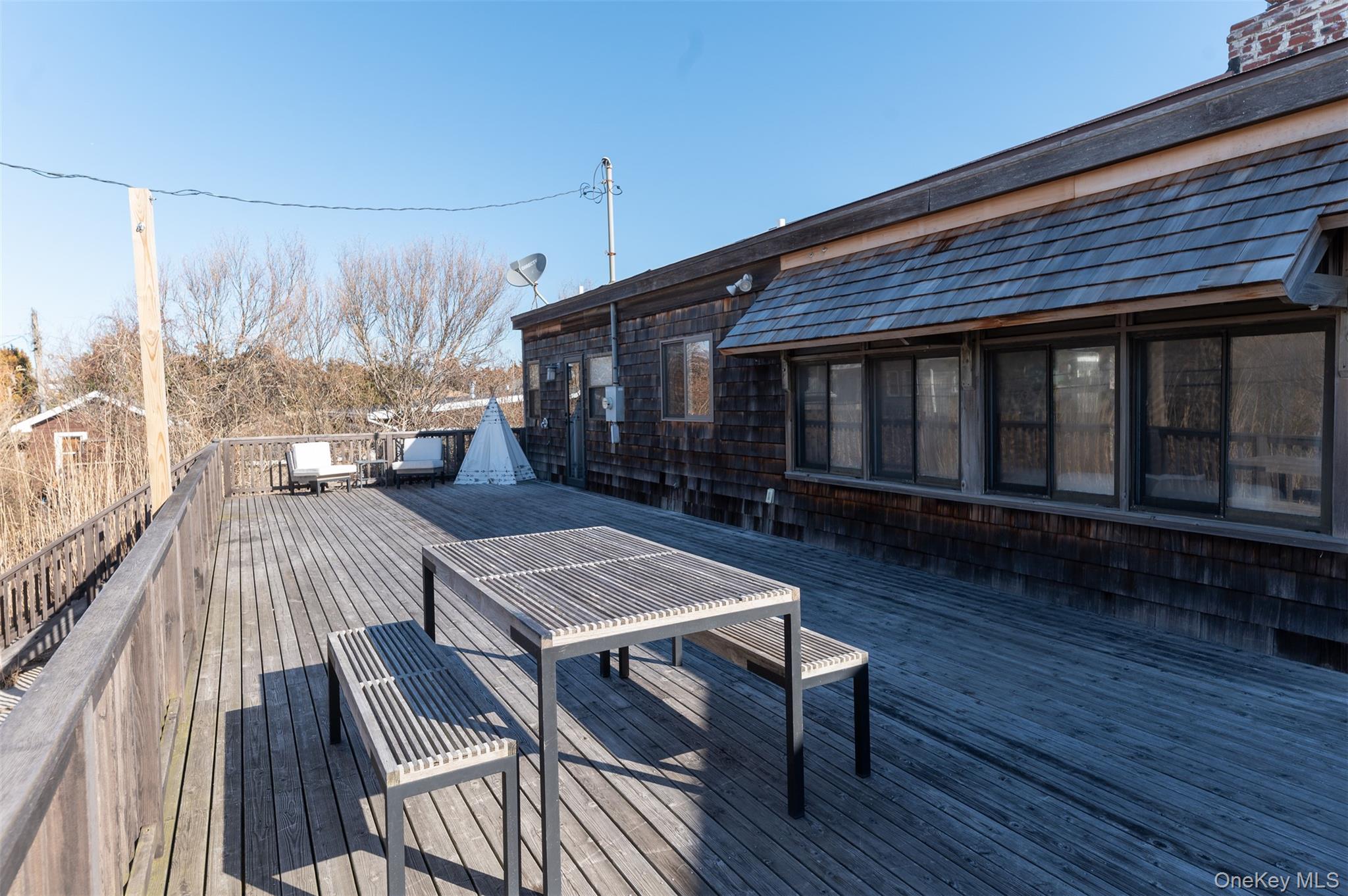 35 Sloop Walk Ocean Beach, NY 11770 - Photo 19 of 21 a living room with couch a dining table and a wooden floor