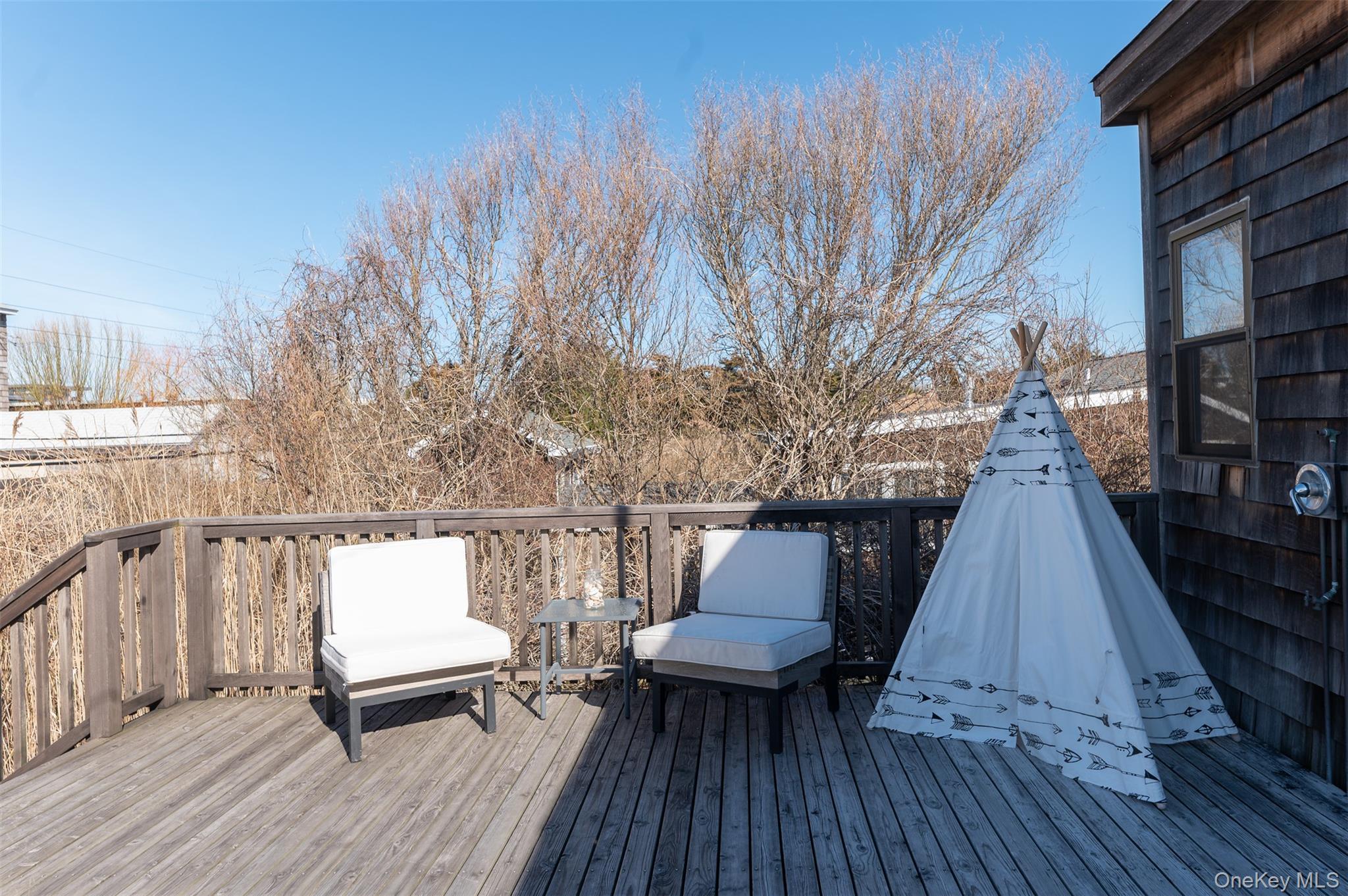 35 Sloop Walk Ocean Beach, NY 11770 - Photo 21 of 21 a view of sitting area on roof with wooden floor and fence
