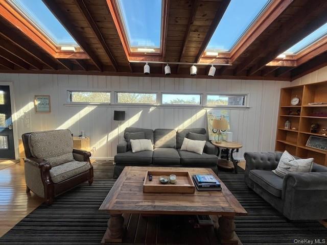 35 Sloop Walk Ocean Beach, NY 11770 - Photo 6 of 21 Living area with beamed ceiling, wood finished floors, and a skylight