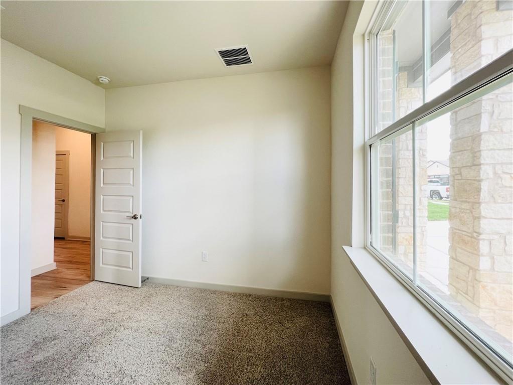 10600 Defender Trail Austin, TX 78754 - Photo 12 of 21 Empty room featuring light carpet and baseboards