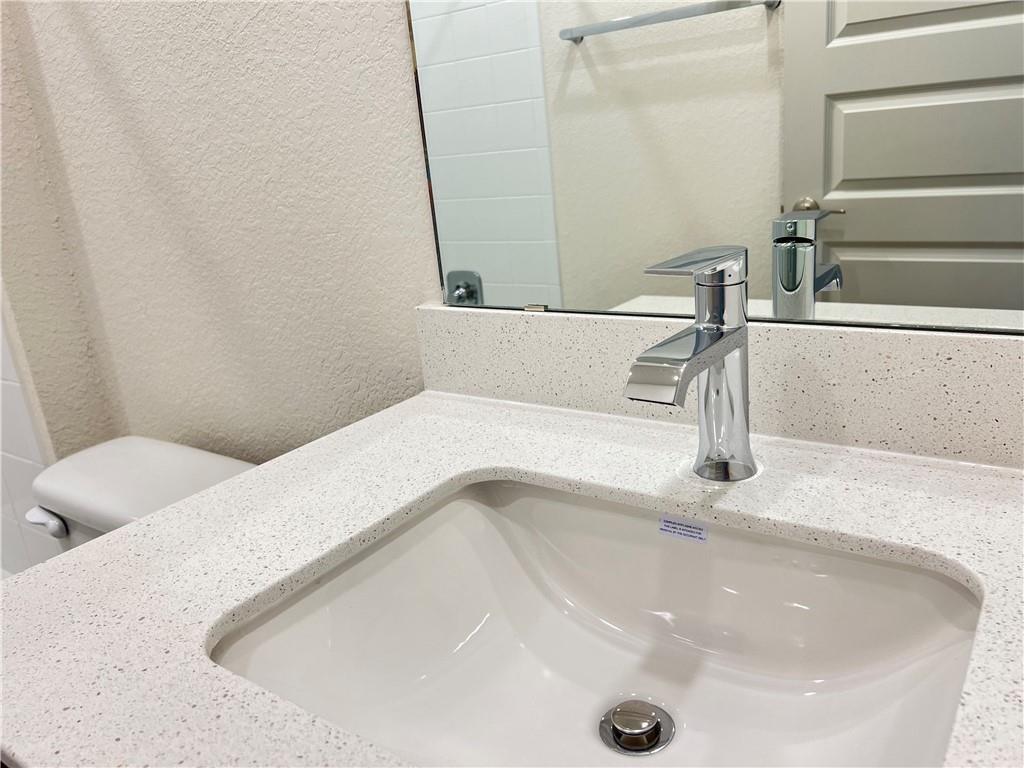 10600 Defender Trail Austin, TX 78754 - Photo 15 of 21 Bathroom view of vanity and a textured wall