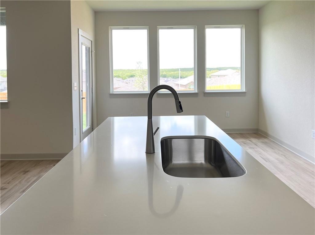 10600 Defender Trail Austin, TX 78754 - Photo 4 of 21 Kitchen view of light wood-style flooring and light stone counters