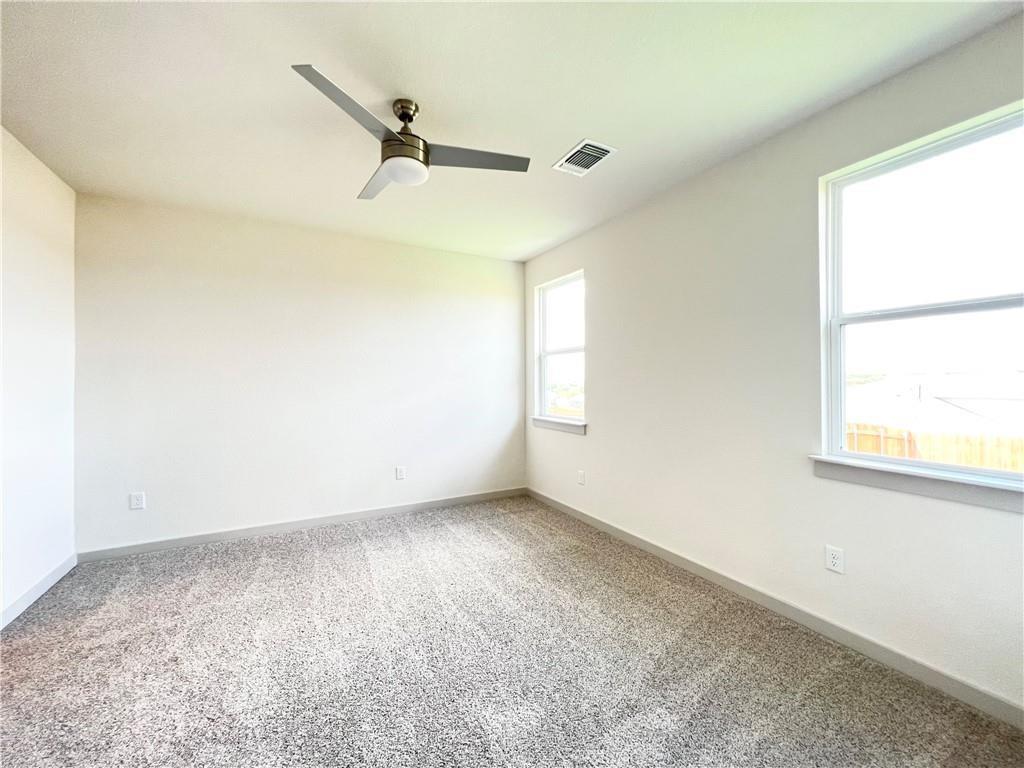 10600 Defender Trail Austin, TX 78754 - Photo 7 of 21 Unfurnished room with light carpet and ceiling fan