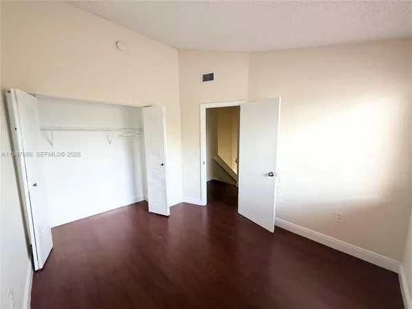 an empty room with wooden floor