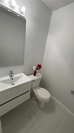 a white toilet sitting next to a bathroom sink