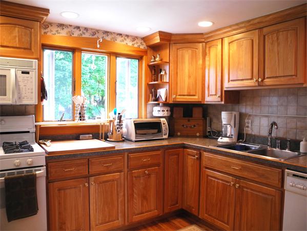 10 Fielding Road Reading, MA 01867 - Photo 3 of 17 a kitchen with stainless steel appliances granite countertop a sink a stove and a refrigerator