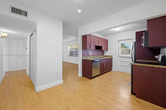 a kitchen with stainless steel appliances a refrigerator and a stove