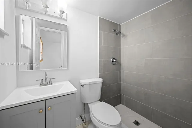 a bathroom with a toilet sink shower and mirror