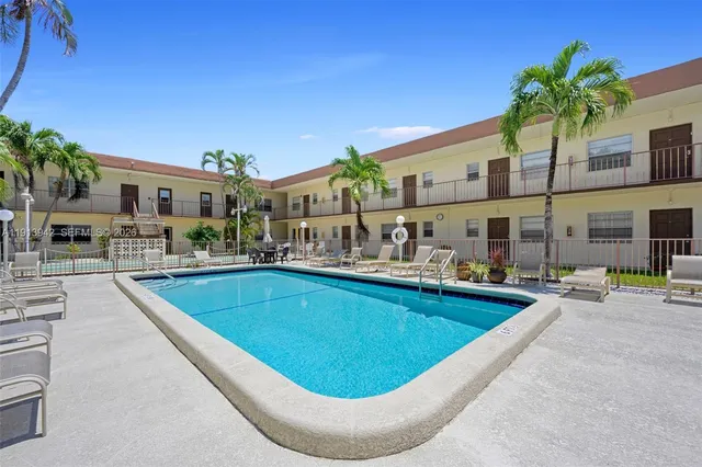 a view of a swimming pool with chairs