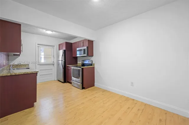 a kitchen with stainless steel appliances a refrigerator and a stove top oven