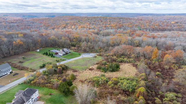 an aerial view of a houses with yard