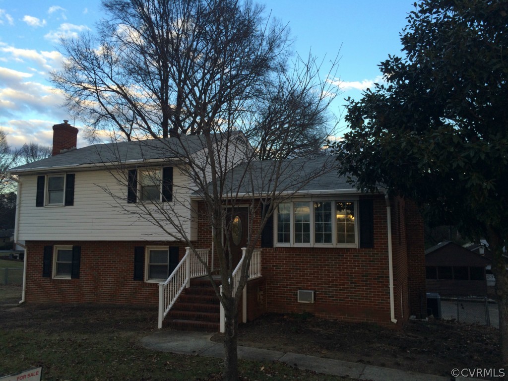 a front view of a house with plants