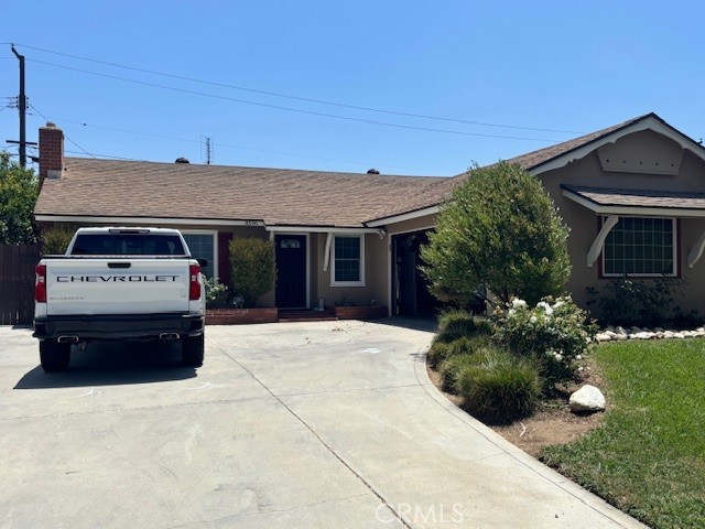 8596 Camelia Drive Riverside, CA 92504 - Photo 1 of 1 a car parked in front of white house